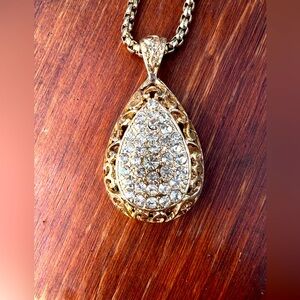 Teardrop goldtone pendant filled with rhinestones; sparklingly glamorous !!